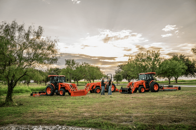 People standing in front of a tractor lineup outside