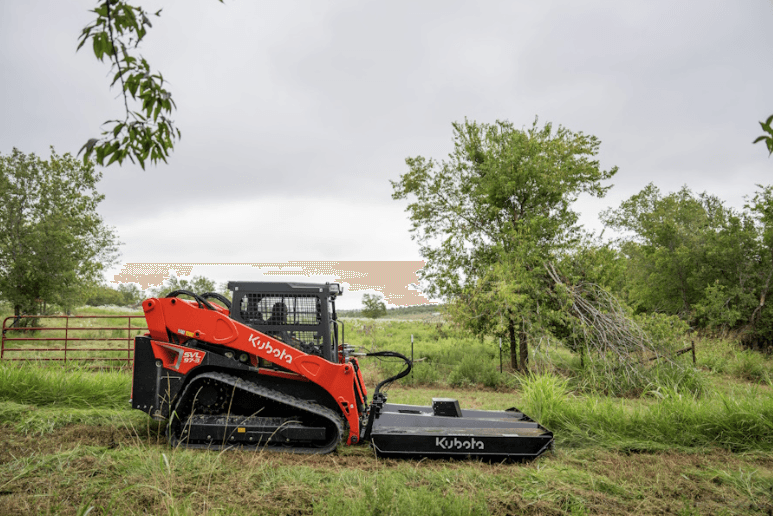 Loader using front attachment to mow down grass