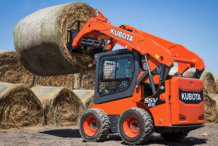 Skid Steer loading hay bale on top of each other