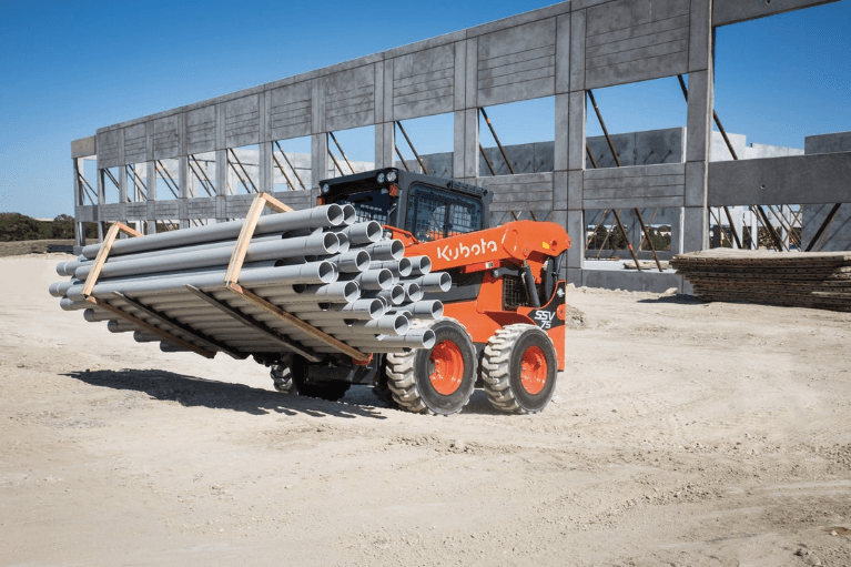 Loader moving pallet of pipes