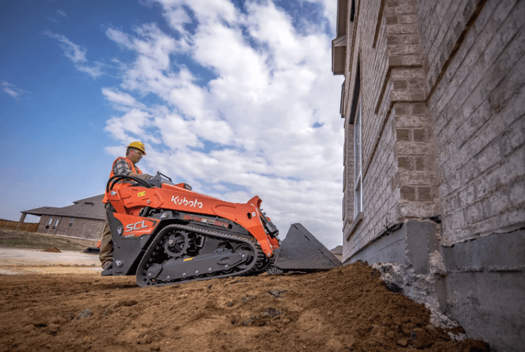 Man operating a stand-on loader