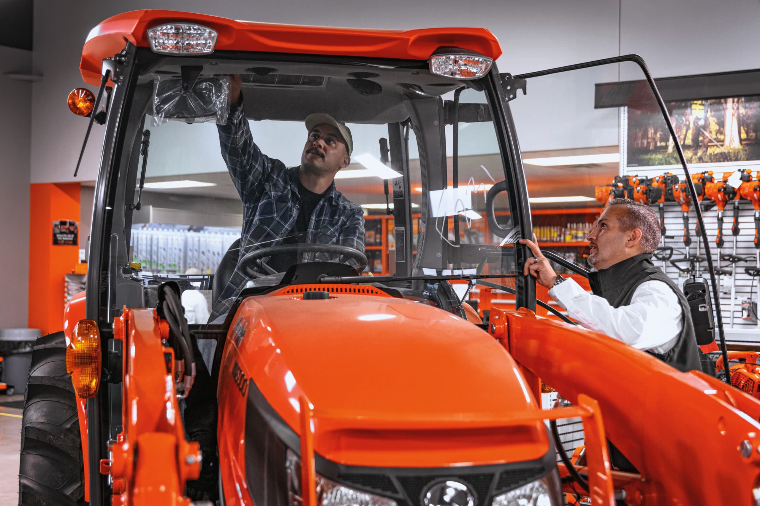 two men looking at kubota tractor