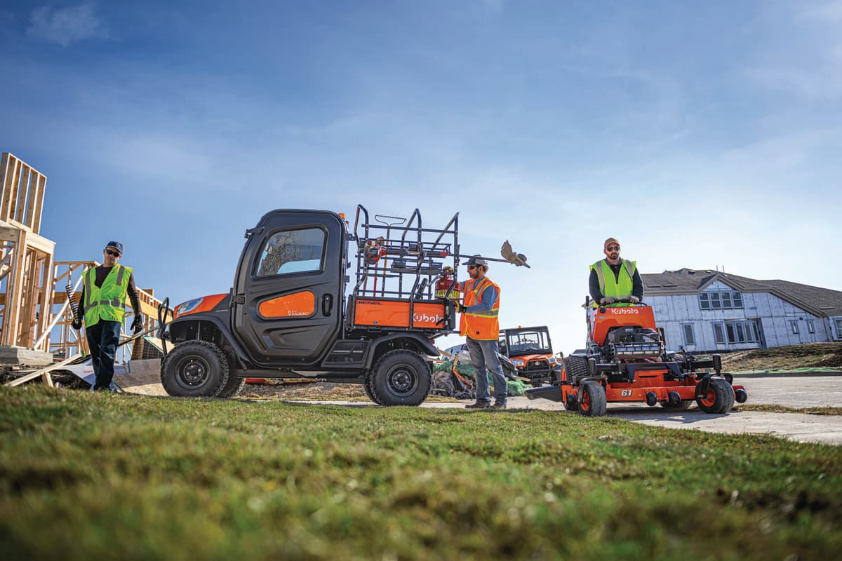 Kubota UTV and stand-on mower being used by a landscaping crew
