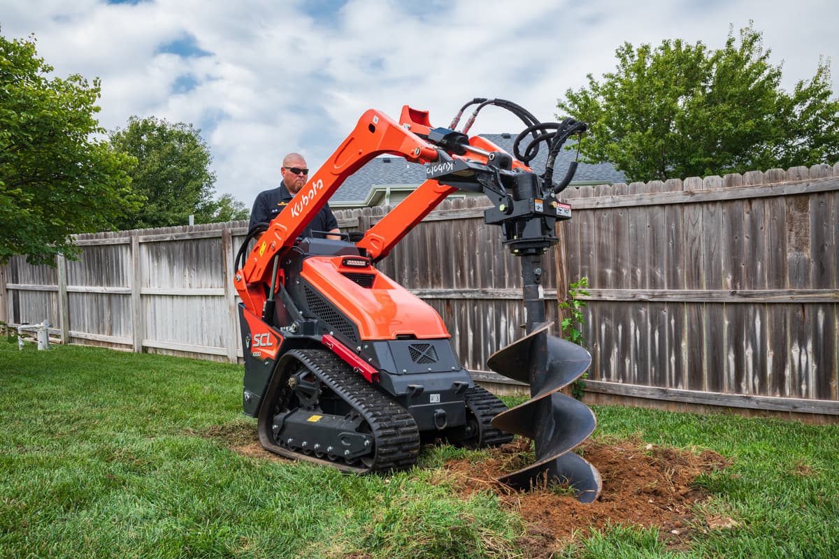 Land Pride post hole digger on a Kubota stand-on compact loader