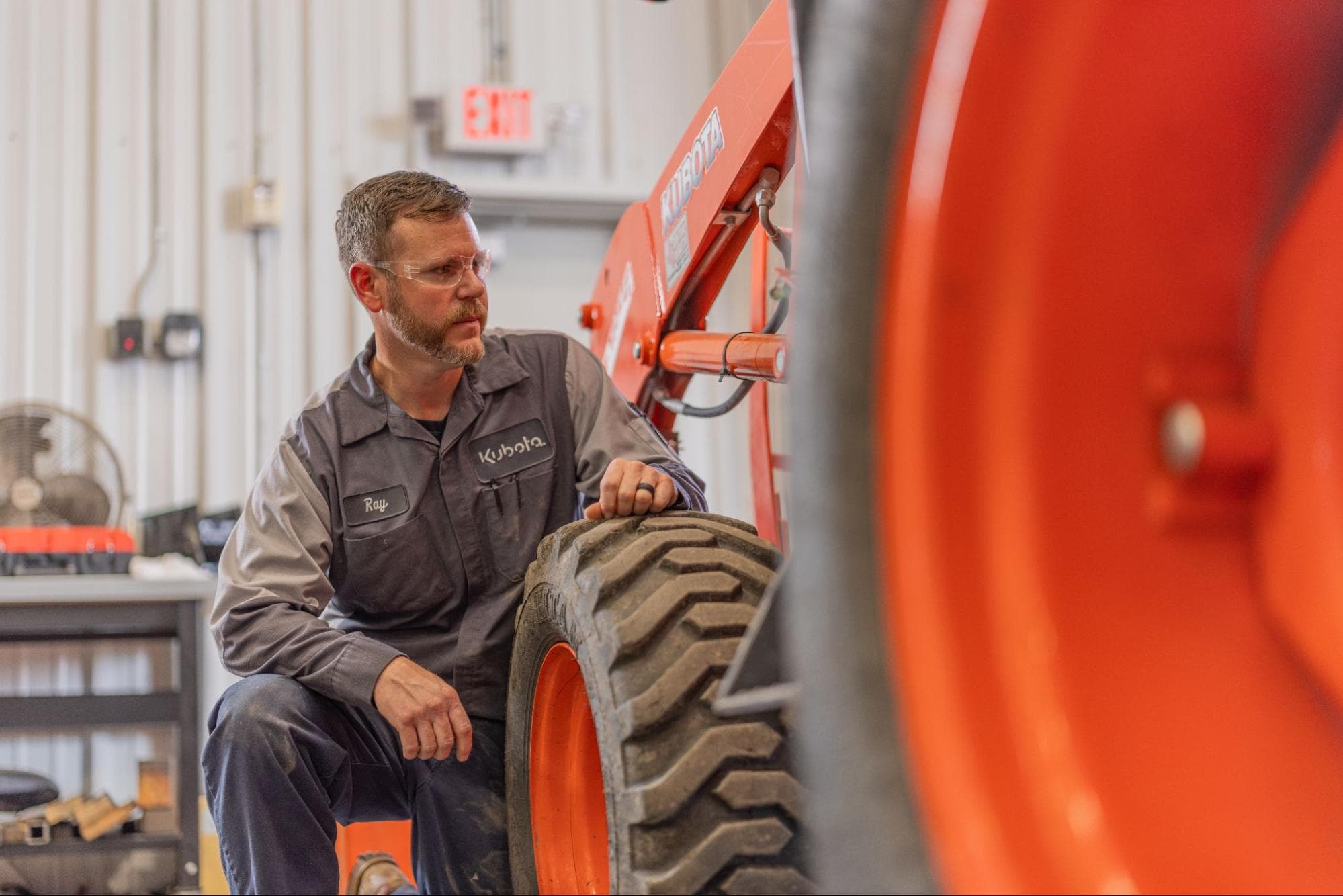 service member looking at kubota tractor
