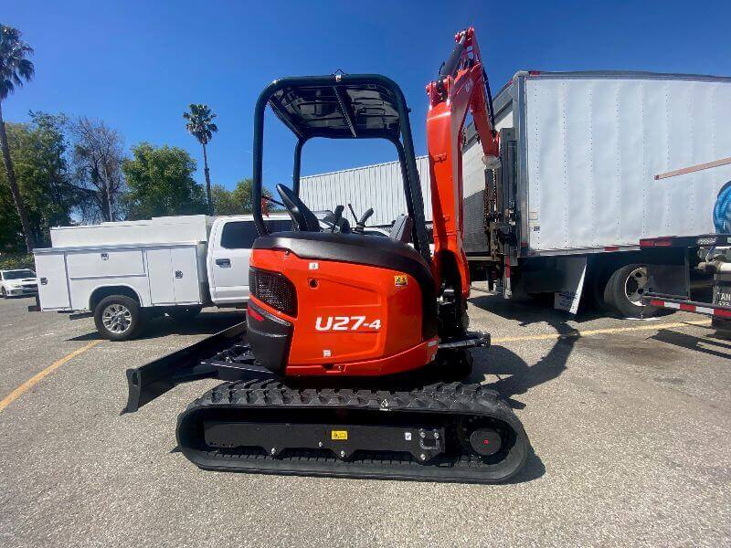 Kubota tractor in parking lot by trucks by Mission Valley Kubota